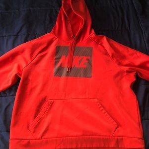 Large Red Nike DRI-FIT hoodie, comfortable inside fabrics, graphic logo.
